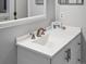 Bathroom vanity with white countertop and bronze faucet with white framed mirror at 4226 S Eldridge St # 207, Morrison, CO 80465