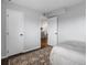 Bedroom with dark wood floors, light gray walls, white bedspread and bright light at 4226 S Eldridge St # 207, Morrison, CO 80465