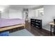Spacious bedroom featuring dark hardwood floors, white walls, and ensuite bathroom at 4226 S Eldridge St # 207, Morrison, CO 80465