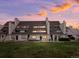 A charming townhome featuring a well-maintained lawn and serene outdoor living space with a beautiful sunset at 4226 S Eldridge St # 207, Morrison, CO 80465