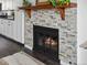Stone fireplace with wooden mantel and gas insert offers a cozy focal point in the living space at 4226 S Eldridge St # 207, Morrison, CO 80465