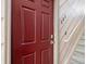 A vibrant red door with a modern lock and gold knob at 4226 S Eldridge St # 207, Morrison, CO 80465