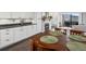 Open kitchen and dining area with white cabinetry, stone fireplace and mountain view at 4226 S Eldridge St # 207, Morrison, CO 80465