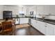 Modern kitchen boasts white cabinets, stainless steel appliances, and dark countertops at 4226 S Eldridge St # 207, Morrison, CO 80465