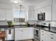 Well-lit kitchen features white cabinetry, black countertops, and stainless steel appliances at 4226 S Eldridge St # 207, Morrison, CO 80465
