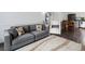 Inviting living room with stylish gray sofa, patterned rug, and an open layout to the dining area at 4226 S Eldridge St # 207, Morrison, CO 80465