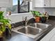 Stainless steel sink with modern faucet and view to the neighborhood outside the window at 4226 S Eldridge St # 207, Morrison, CO 80465