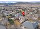 Aerial view showcasing the house, backyard, and surrounding neighborhood at 8430 S Oak St, Littleton, CO 80127