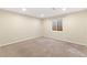 Basement bedroom featuring neutral walls, carpeting, and a window for natural light at 3355 S Emerson St, Englewood, CO 80113