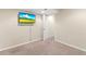 Finished basement with TV, neutral walls, carpeting, and access door at 3355 S Emerson St, Englewood, CO 80113