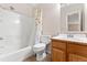 Full bathroom featuring a shower-tub combo and a classic vanity with ample storage at 3355 S Emerson St, Englewood, CO 80113