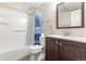 Basement bathroom with a shower-tub combo, toilet, vanity, and mirror at 3355 S Emerson St, Englewood, CO 80113
