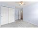 Bedroom with plush carpet, ceiling fan, light-blue painted walls, and a roomy closet at 3355 S Emerson St, Englewood, CO 80113