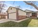 Charming home featuring a well-manicured lawn, two-car garage and traditional brick accents at 3355 S Emerson St, Englewood, CO 80113