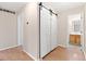 Hallway with hardwood floors, sliding closet doors, and access to the bathroom at 3355 S Emerson St, Englewood, CO 80113