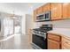 Modern kitchen features stainless steel appliances and access to the outdoor living space at 3355 S Emerson St, Englewood, CO 80113