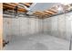 Unfinished basement with exposed ceiling and concrete walls, providing ample storage space at 3355 S Emerson St, Englewood, CO 80113