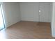 A small and empty living room space with laminate floors and access to a sliding glass door at 10772 E Exposition Ave Ave # 342, Aurora, CO 80012