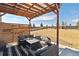 Inviting covered patio with stylish seating, perfect for outdoor relaxation and entertaining in the expansive backyard at 15507 Quince Cir, Thornton, CO 80602