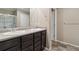 Bathroom features double sinks, dark wood cabinets, modern fixtures, and a separate shower area at 15507 Quince Cir, Thornton, CO 80602