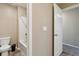 Bathroom with bathtub and tile surround, toilet, and neutral walls creating a functional space at 15507 Quince Cir, Thornton, CO 80602