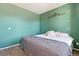 Cozy bedroom featuring a comfortable bed, ample natural light, and a soothing green color scheme at 15507 Quince Cir, Thornton, CO 80602