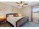 Comfortable bedroom with a wooden bed frame, colorful pillows, and a cozy side table with a lamp at 15507 Quince Cir, Thornton, CO 80602