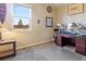 Carpeted bedroom featuring a desk and dual monitor setup, complemented by a window with natural light at 15507 Quince Cir, Thornton, CO 80602