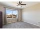 Bedroom with a large window offering natural light and scenic outdoor views at 15507 Quince Cir, Thornton, CO 80602