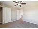 Bright bedroom featuring carpet floors, ceiling fan and open closet with white doors at 15507 Quince Cir, Thornton, CO 80602