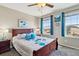 Bedroom with large windows, a ceiling fan, and comfortable decor offers an inviting atmosphere at 15507 Quince Cir, Thornton, CO 80602