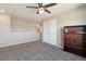 Cozy bedroom with carpet flooring and a built-in bookshelf near a closet with white doors at 15507 Quince Cir, Thornton, CO 80602