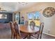 The dining room features a wooden table and chairs, with a view of the backyard through the sliding glass door at 15507 Quince Cir, Thornton, CO 80602