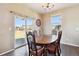 Bright dining room boasts hardwood floors, a stylish light fixture, and sliding door access to the backyard at 15507 Quince Cir, Thornton, CO 80602