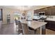 Elegant kitchen with a large island, granite countertops, and modern appliances at 15507 Quince Cir, Thornton, CO 80602