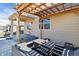 Outdoor patio area covered by a pergola, complete with stylish patio furniture and lighting at 15507 Quince Cir, Thornton, CO 80602