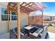 Inviting outdoor patio space featuring comfortable seating and a pergola at 15507 Quince Cir, Thornton, CO 80602