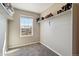 Clean and organized walk-in closet has neutral carpeting, shelving, a window for natural light, and white trim at 15507 Quince Cir, Thornton, CO 80602