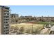 An eye-level aerial shot of a neighborhood with a large field, track and buildings at 601 W 11Th Ave # 815, Denver, CO 80204