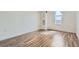 Bright bedroom featuring hardwood floors, white walls, baseboard trim, and bright natural light at 601 W 11Th Ave # 815, Denver, CO 80204