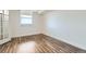 A bright, empty bedroom featuring luxury vinyl flooring and a window at 601 W 11Th Ave # 815, Denver, CO 80204