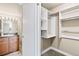 Open closet with shelving and storage racks, next to bathroom at 601 W 11Th Ave # 815, Denver, CO 80204