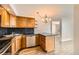 Well-equipped kitchen with stainless steel appliances, wood cabinets, and granite countertops at 601 W 11Th Ave # 815, Denver, CO 80204