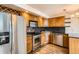 A well-lit kitchen boasts stainless steel appliances, wood cabinets, and stone countertops at 601 W 11Th Ave # 815, Denver, CO 80204