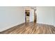 Open-concept living room featuring hardwood floors, white walls, and a doorway to the kitchen at 601 W 11Th Ave # 815, Denver, CO 80204