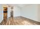 Living room featuring hardwood floors, white walls, baseboard trim, and doorway leading to the kitchen at 601 W 11Th Ave # 815, Denver, CO 80204