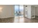 Bright living room with glass sliding doors to a balcony with city views and a glass panel door at 601 W 11Th Ave # 815, Denver, CO 80204