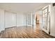 Open living room features luxury vinyl flooring, closet, and glass doors leading to other rooms at 601 W 11Th Ave # 815, Denver, CO 80204