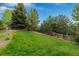 Expansive green backyard featuring mature trees, a wooden fence, and plenty of open space at 24682 E Ontario Dr, Aurora, CO 80016