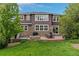 Spacious backyard with stone patio, hot tub, fire pit, and lush green lawn perfect for entertaining at 24682 E Ontario Dr, Aurora, CO 80016